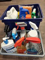 Overall view of two totes with assorted chemical bottles