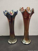 Both Fenton carnival glass vases side by side showing size difference and design
