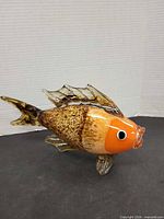 Right side view of full glass fish sculpture displaying colors, fins and tail