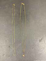 Two gold chains side by side