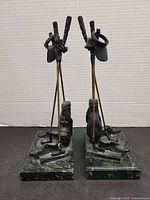 Front view of both golf bookends on marble bases