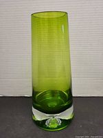 Full frontal view showing vase shape, color, and clear bubble base