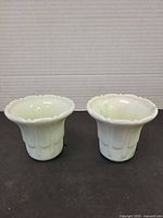Front view of both jadeite slag glass planters