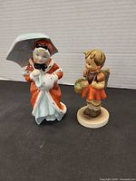 Front view of both figurines showing overall design and scale