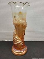 Full view of marigold carnival glass fish vase