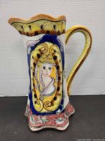 Front view of Majolica pitcher showing portrait medallion and rim