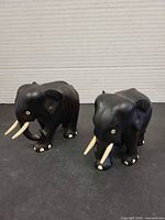 Both dark wood elephant figurines front angled view