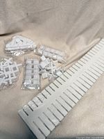 Full kit showing long slotted rail and bags of connectors/dividers