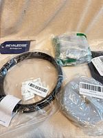 Lot overview showing wire coil, silicone strip roll, Bevledge strap, bag of clips/ties