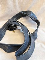 Two coiled black bicycle inner tubes with Schrader valve stems visible