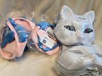 Dog costume sets and cat masks in packaging