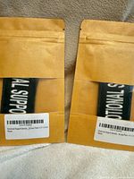 Two sealed kraft envelopes showing patches through window