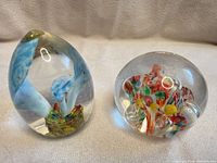 Both paperweights side by side showing overall size and design