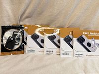 Front view showing four WaveBlock sticker packages and one Pup Culture AirTag holder package