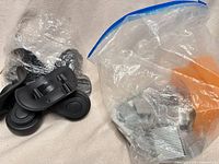 bag of luggage wheels and zip bag of brad nails