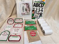 All items in lot displayed: paint-by-number kit, vinyl letters pack, holiday sticker sheets, burlap tags, thermal paper rolls