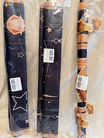 Three rolled banners in plastic