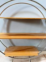 Front view showing full round chrome frame and three bamboo shelves