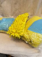 Three packaged yellow chenille shoe washing bags with blue mesh panels