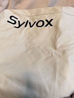 Close view of Sylvox logo on beige fabric