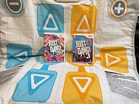 Dance mat laid out with both game cases centered