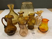 Front view of eight amber and art glass pieces