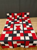Full view of quilt front showing grid pattern and cat panel