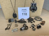 Full lot view showing necklaces on displays and assorted brooches and earrings