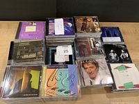 Overview of six stacks of CDs on table