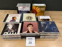 Stacked CDs showing assorted titles in cases