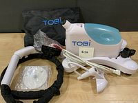 Overall view of steamer, water tank, hose, storage bag, instruction disc and attachments