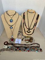 Overall view of necklaces on stands plus items on tabletop