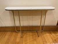 Front view of console table showing faux marble top and gold frame