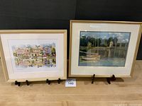 Both framed prints side by side on stands