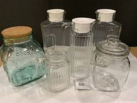 Group shot of all five glass containers showing relative sizes and lids