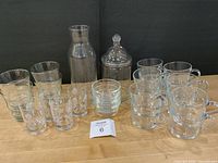 Group shot showing all glassware: wine glasses, juice glasses, tumblers, bowls, canister, pitcher