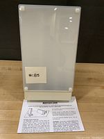 Front view of therapy lamp showing frosted panel and paperwork