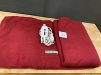 Blanket folded with controller on top showing overall color and fabric