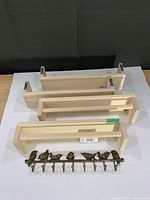 Four birch IKEA shelves and metal bird hook rail laid out