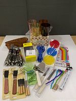 All items laid out including glasses, flatware, spreaders, straws, scrubbers, accessories