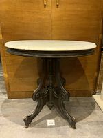 Front view showing marble top and pedestal