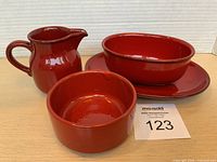 Set of four red ceramic pieces displayed together