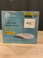 Front view of sealed TP-Link TD-W9970 modem router box