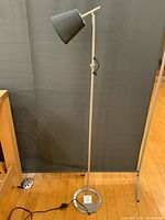 Full view of lamp showing base, pole, shade and cord