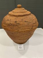 Front view of woven reed basket with lid on