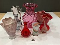 Front view showing all eight vases with varying colors and shapes