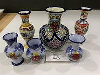 Front view of all six vases showing designs and sizes