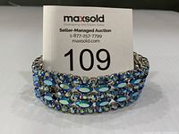 Front view of bracelet standing upright, showing five rows of blue Aurora Borealis stones