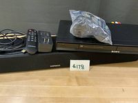 Meredo sound bar, Sony DVD player, bagged accessories, remote, adapter, cable in overview