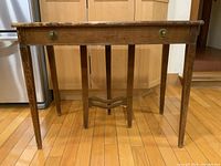 Front view showing full desk, legs, stretcher and drawer